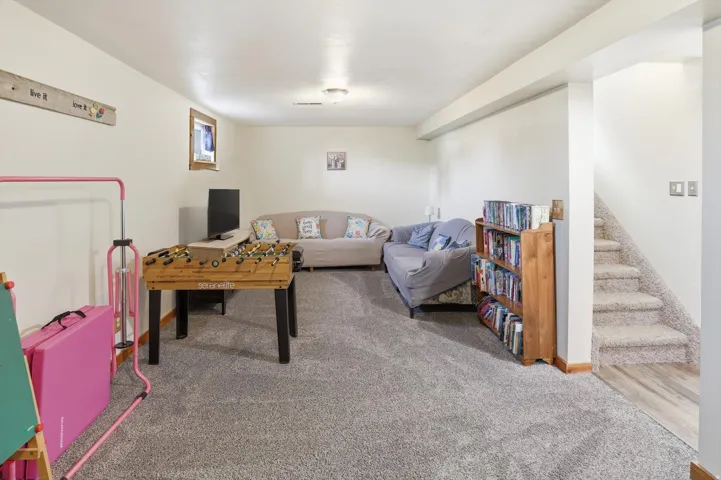 Playroom with light colored carpet and baseboards