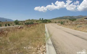 View of asphalt street with a view of countryside and a mountain view