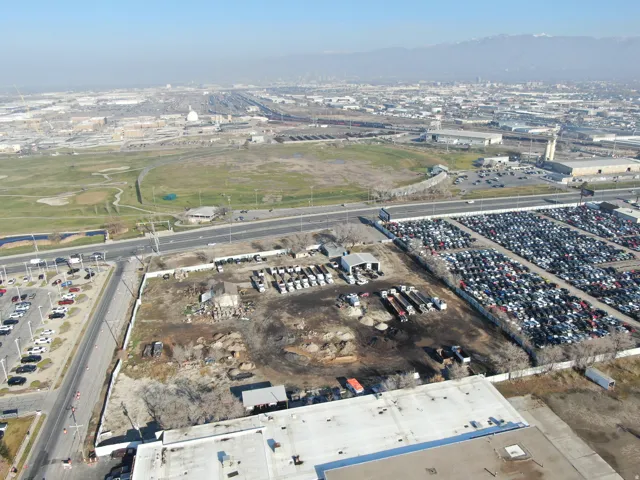 Aerial view of property and surrounding area with industrial structures