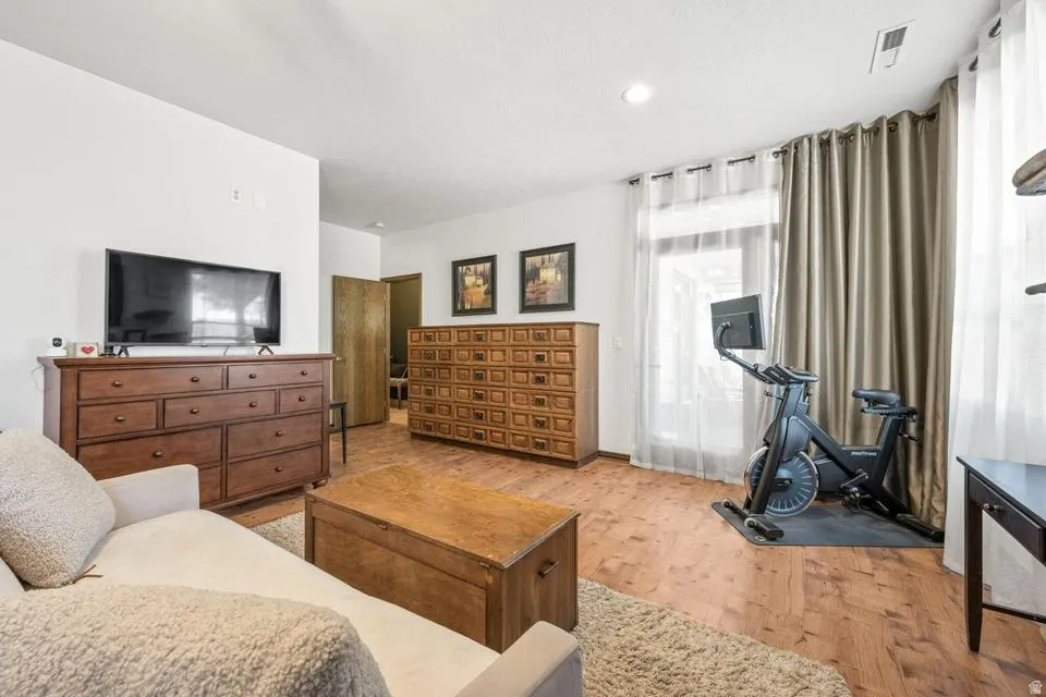 Bedroom with light wood-style floors and recessed lighting