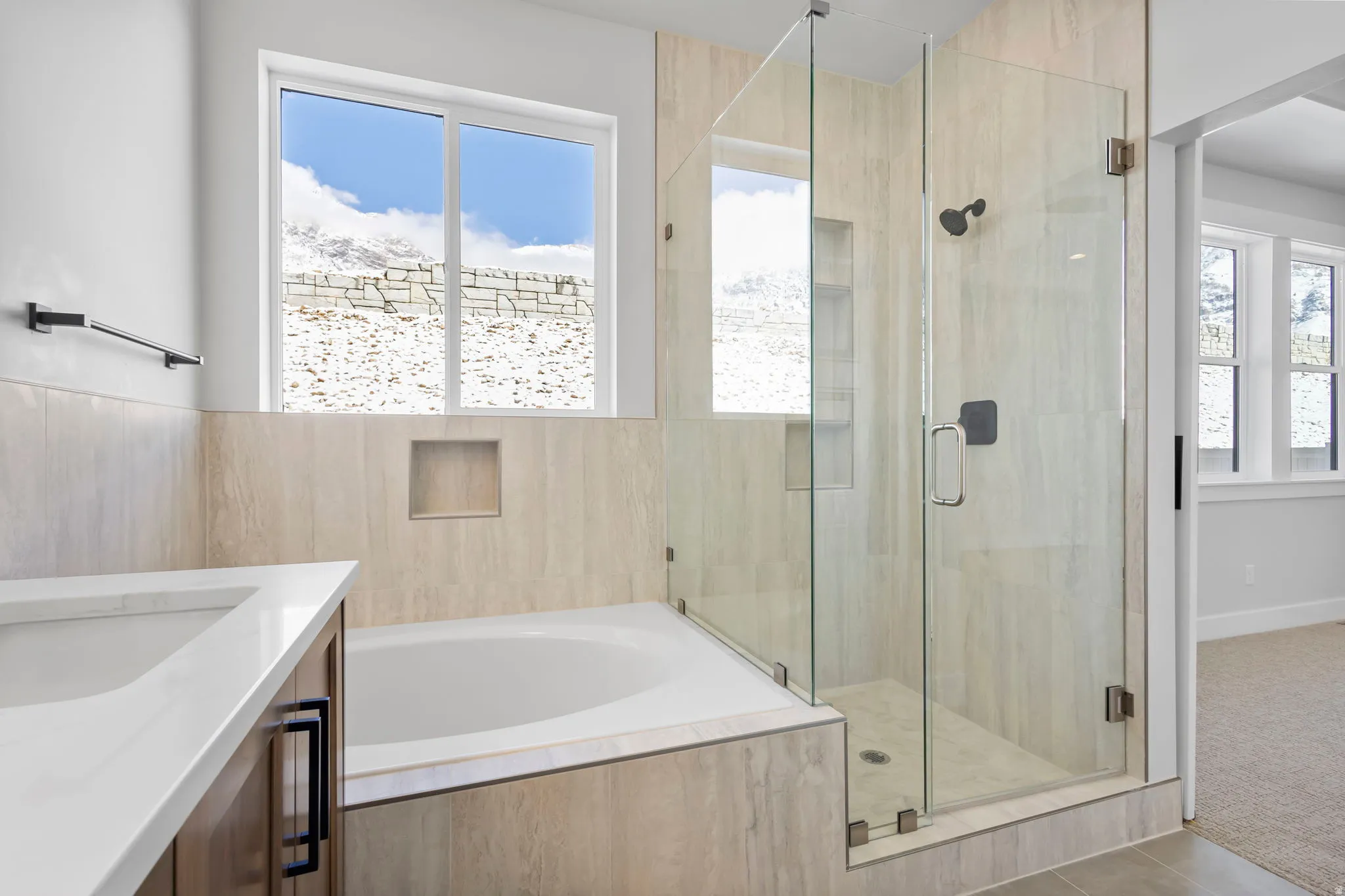 Bathroom featuring vanity, a stall shower, a garden tub, carpet flooring, and healthy amount of natural light
