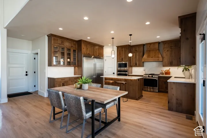 Open-concept kitchen with wood-finish flooring, recessed lighting, and a kitchen island