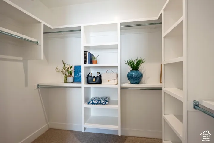 Custom closet organization system with multiple shelving units, integrated hanging rods, and built-in vertical storage