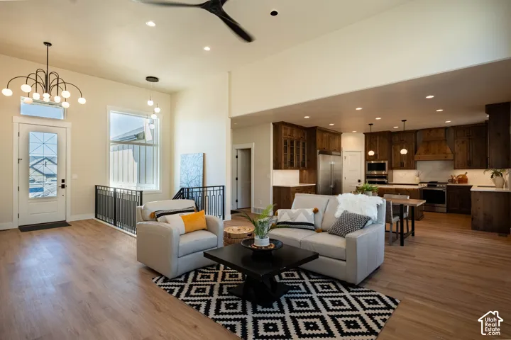 Open concept living area with wood-finish flooring, recessed lighting, and a modern ceiling fan