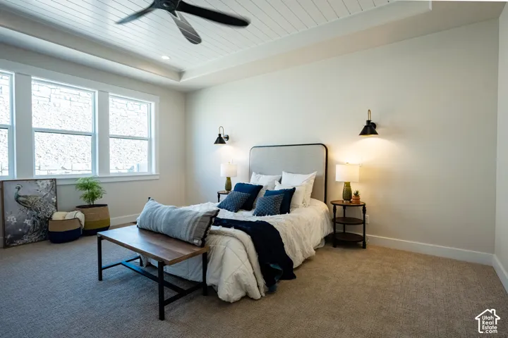 Tray ceiling with shiplap detail, recessed lighting, and a ceiling fan