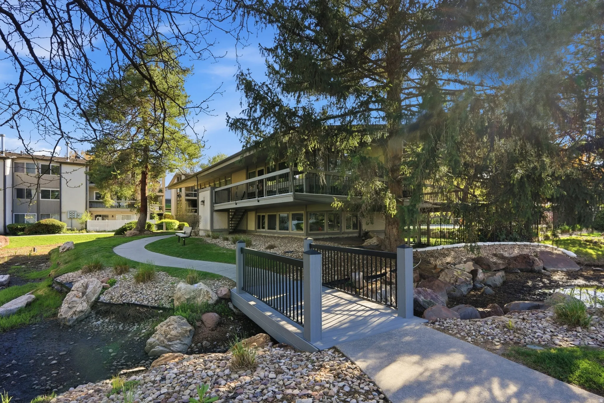 View of home's community with a water feature and a balcony