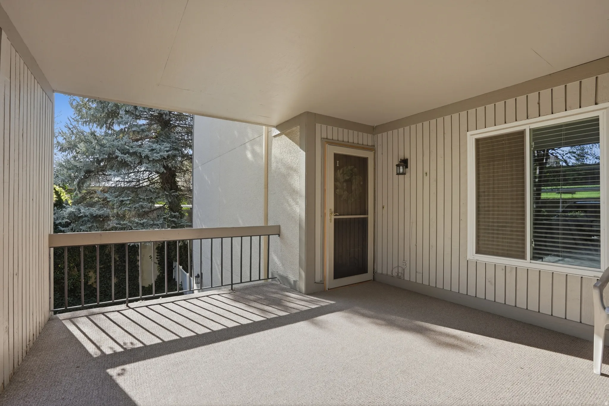 View of exterior entry with a patio area