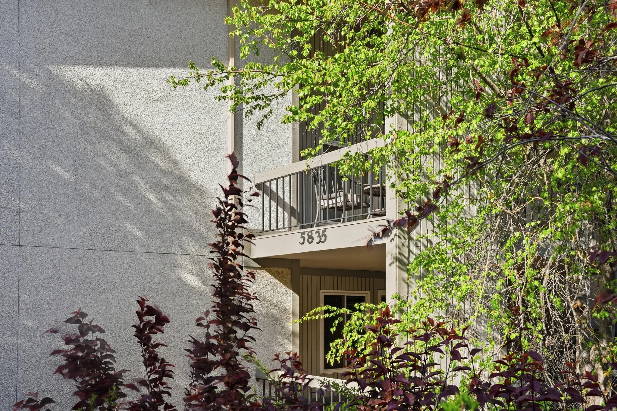 View of home's exterior with a balcony and stucco siding