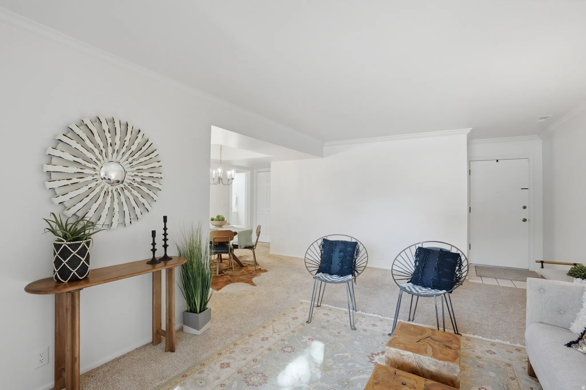 Living area with crown molding and hanging lights