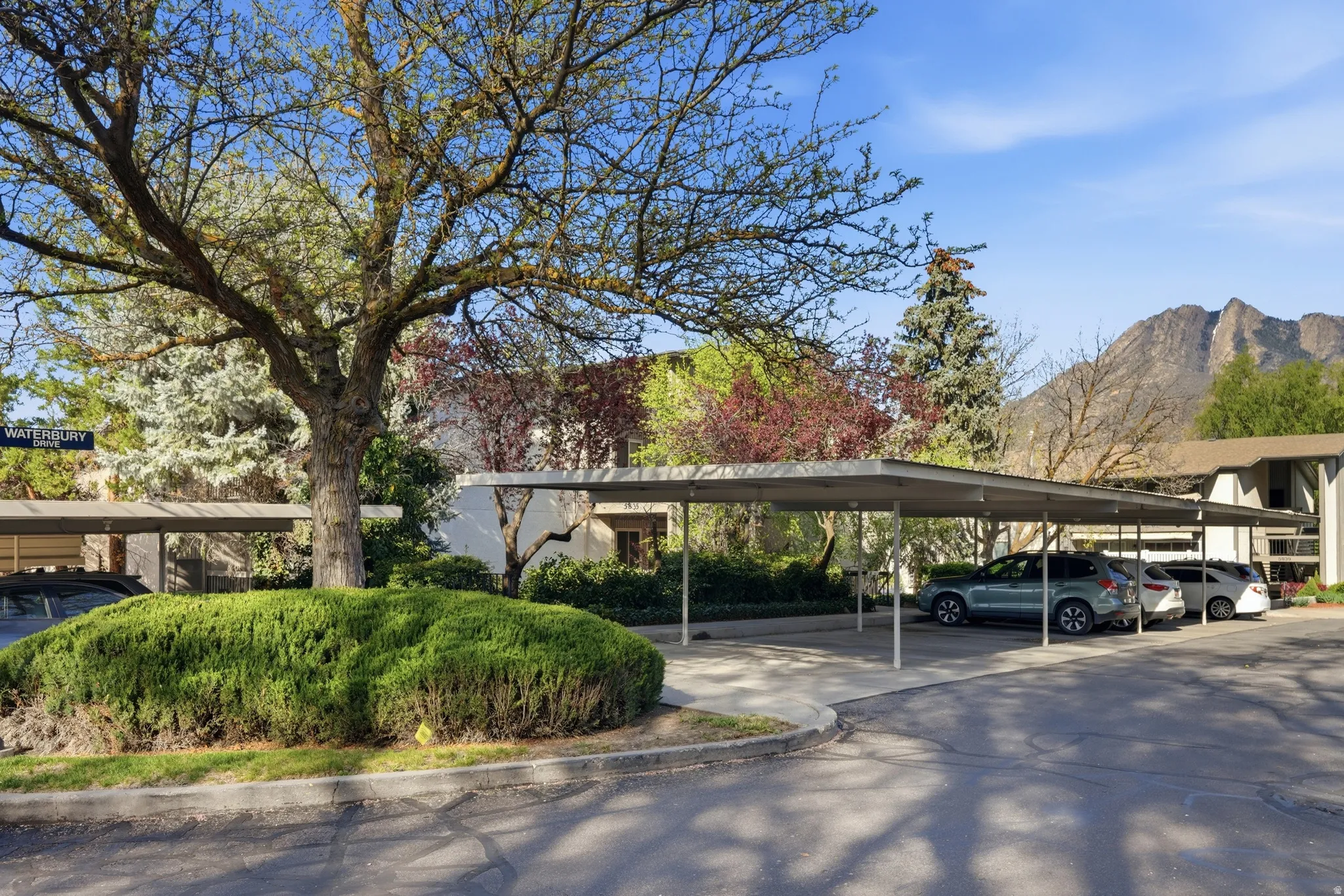 Covered parking lot featuring a mountain view