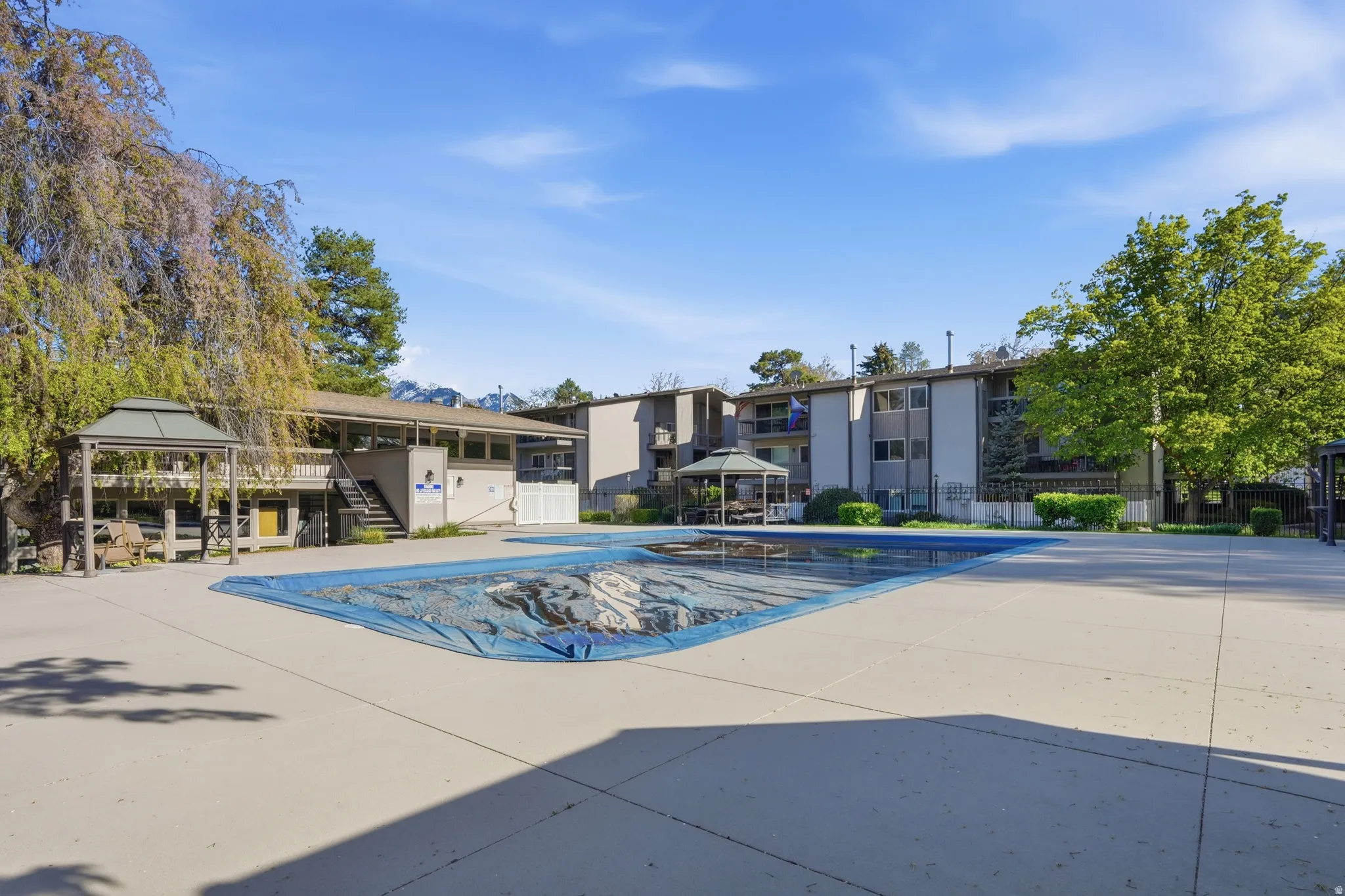 Community pool featuring a gazebo and a patio area