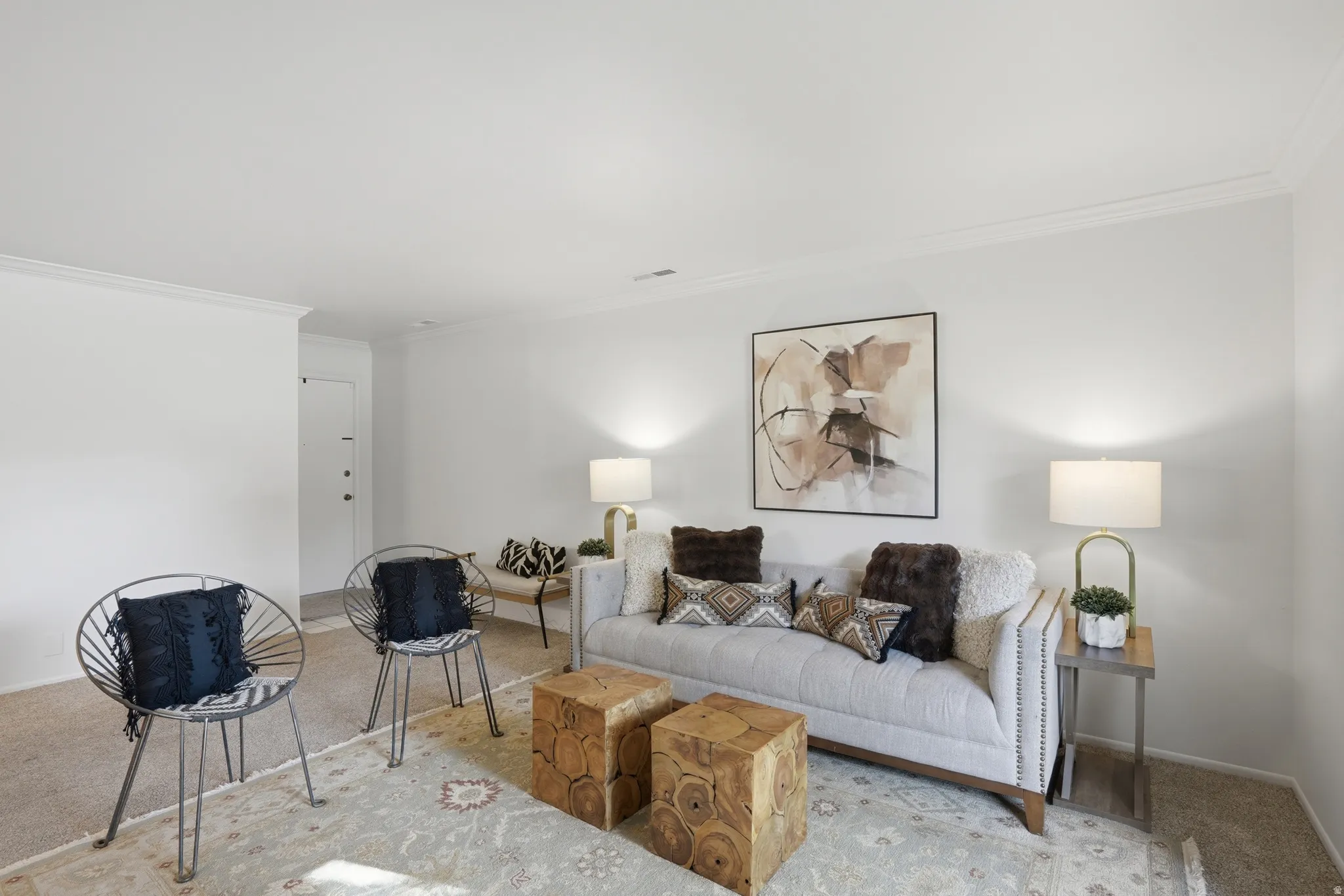 Carpeted living room with crown molding