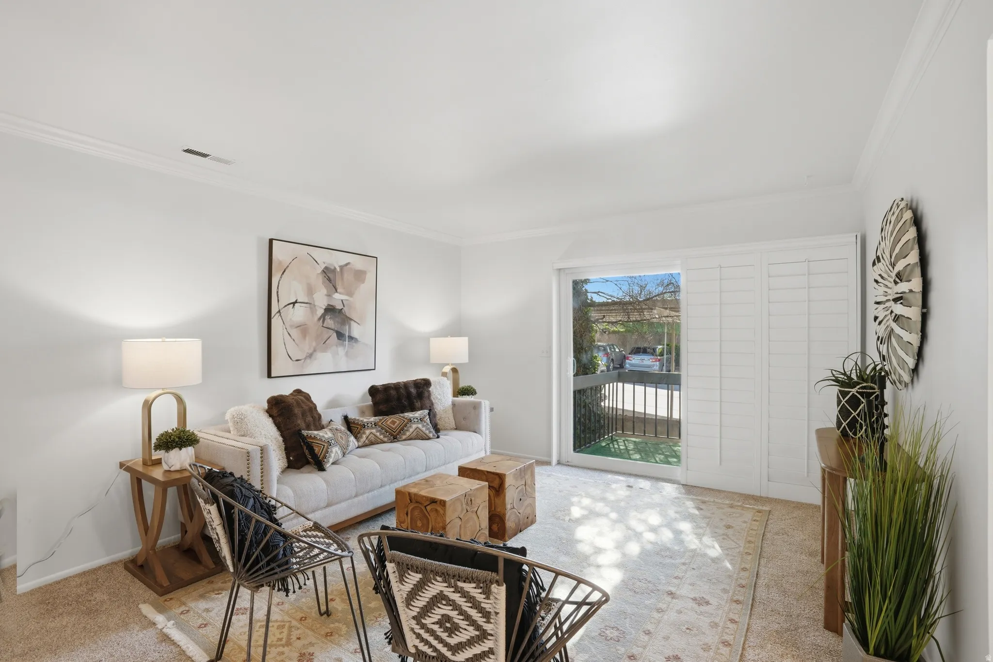 Living room featuring ornamental molding and light carpet