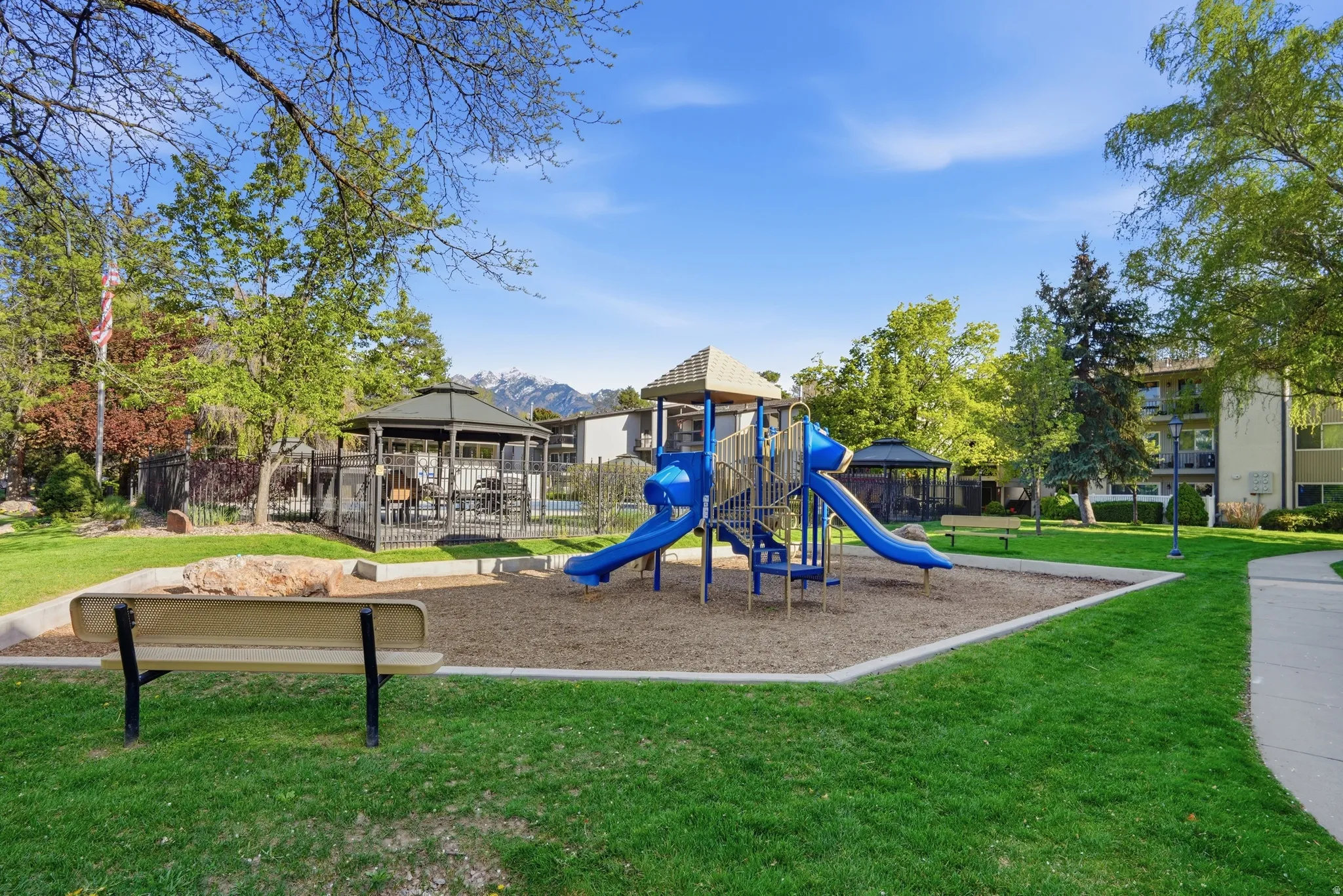 Community playground with a yard, a gazebo, and a patio area