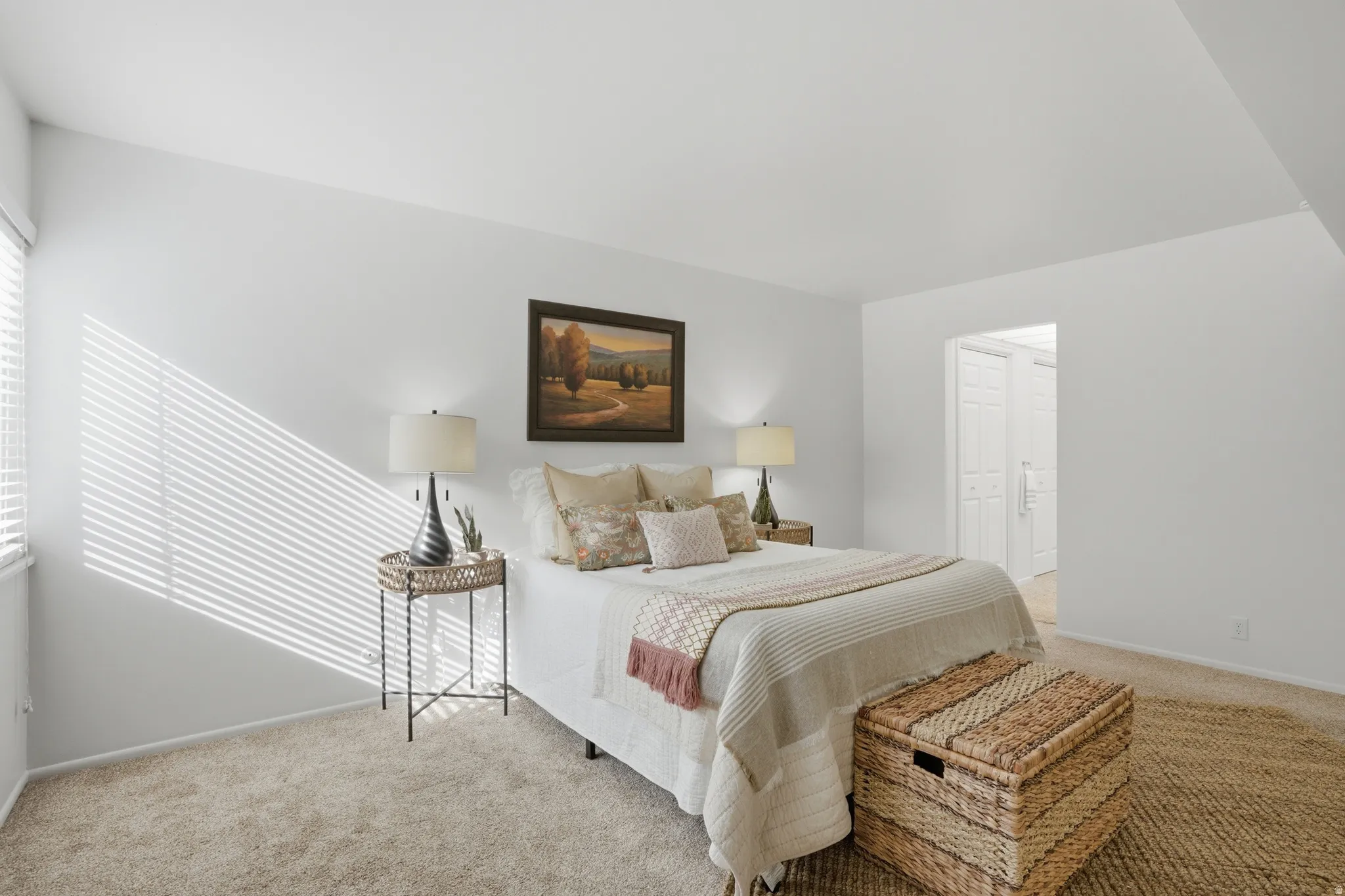 Bedroom featuring light colored carpet and baseboards