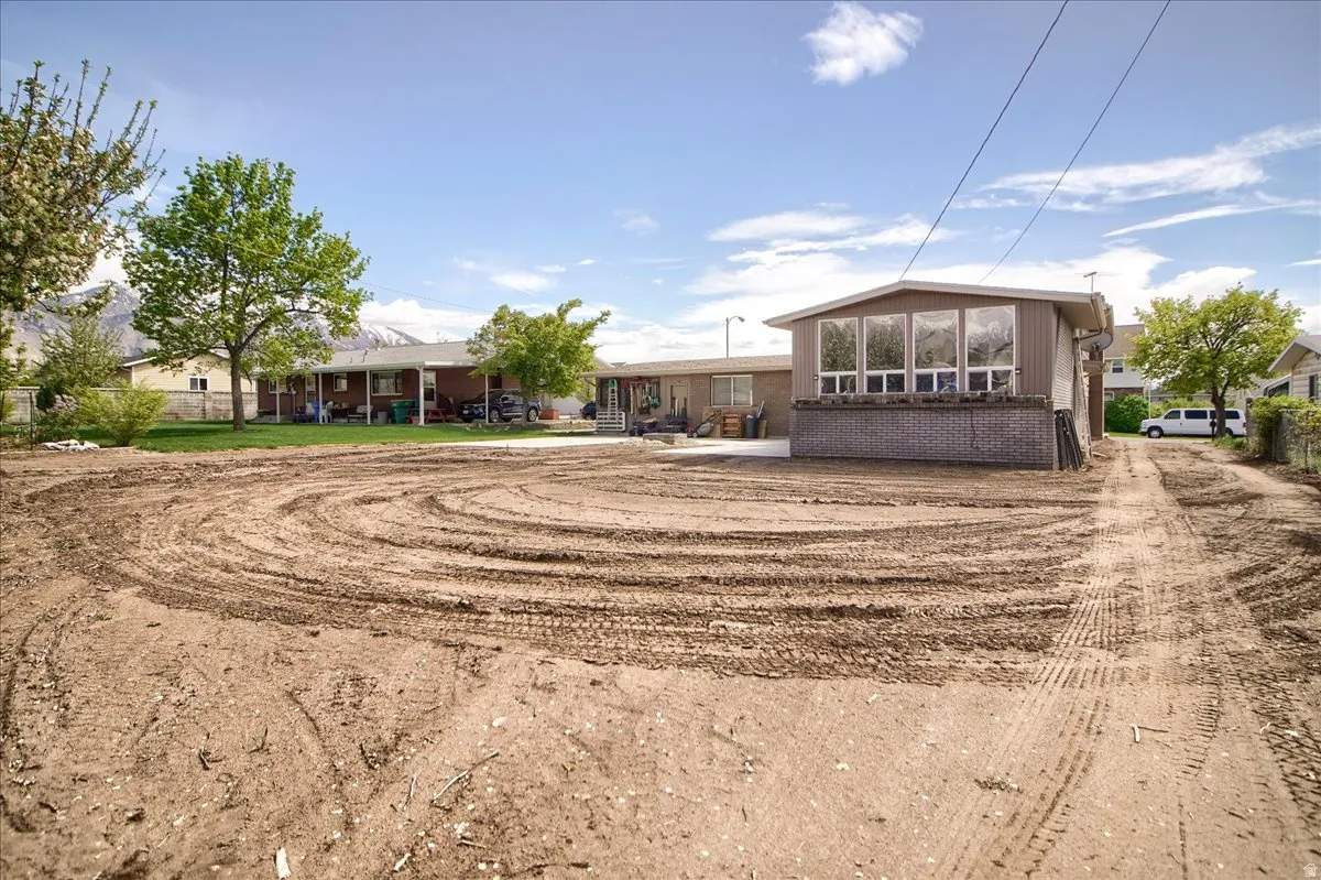 Back of property with a patio and brick siding