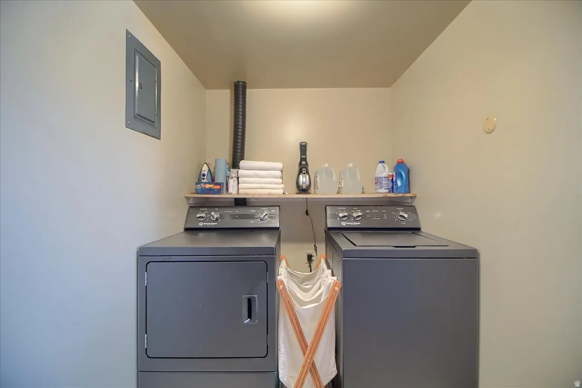 Laundry area with electric panel and washer and clothes dryer