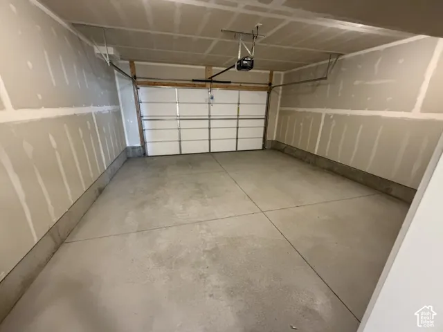 Garage featuring a garage door opener