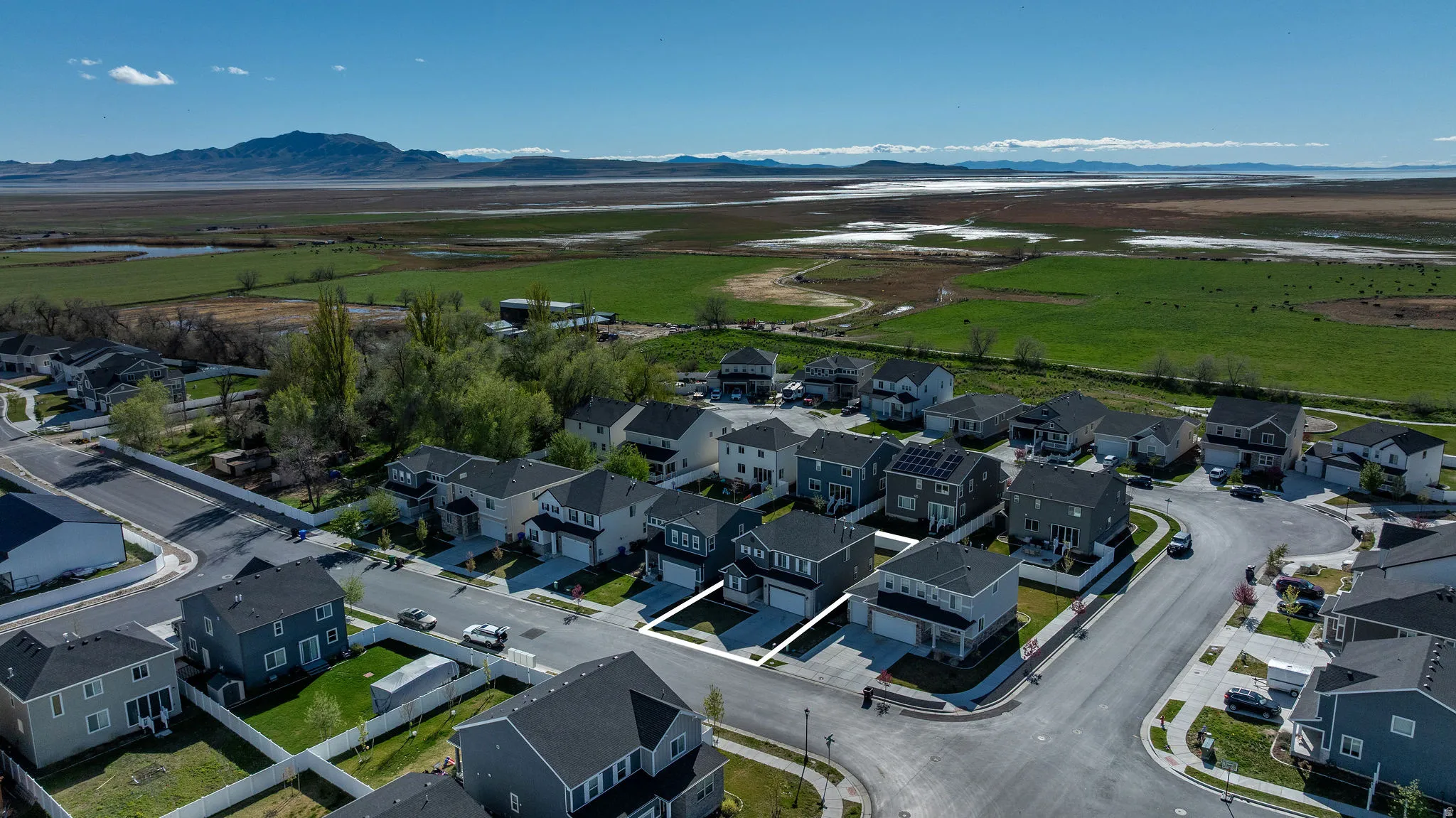Aerial view of residential area featuring a mountainous background