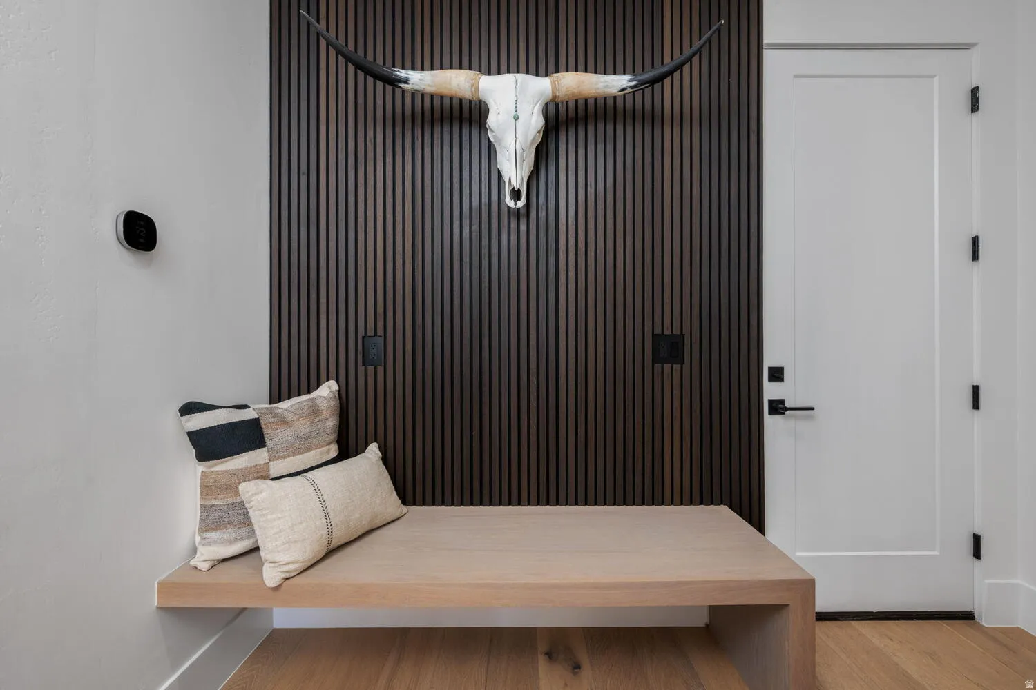 Mudroom featuring baseboards and light wood-type flooring