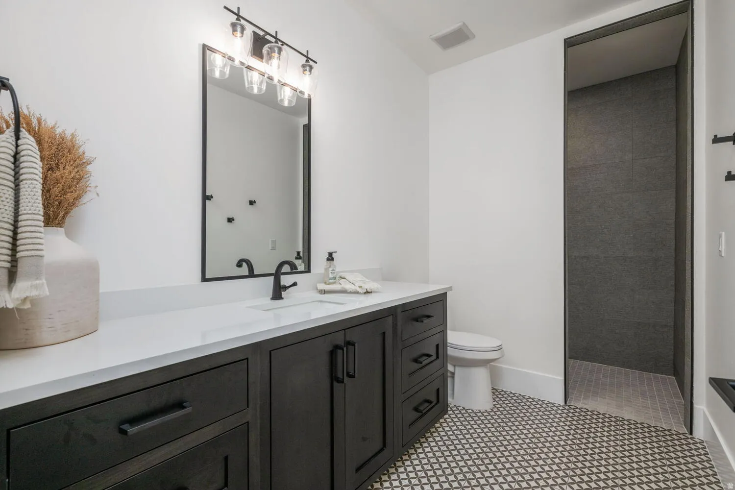 Full bath featuring a walk in shower and vanity