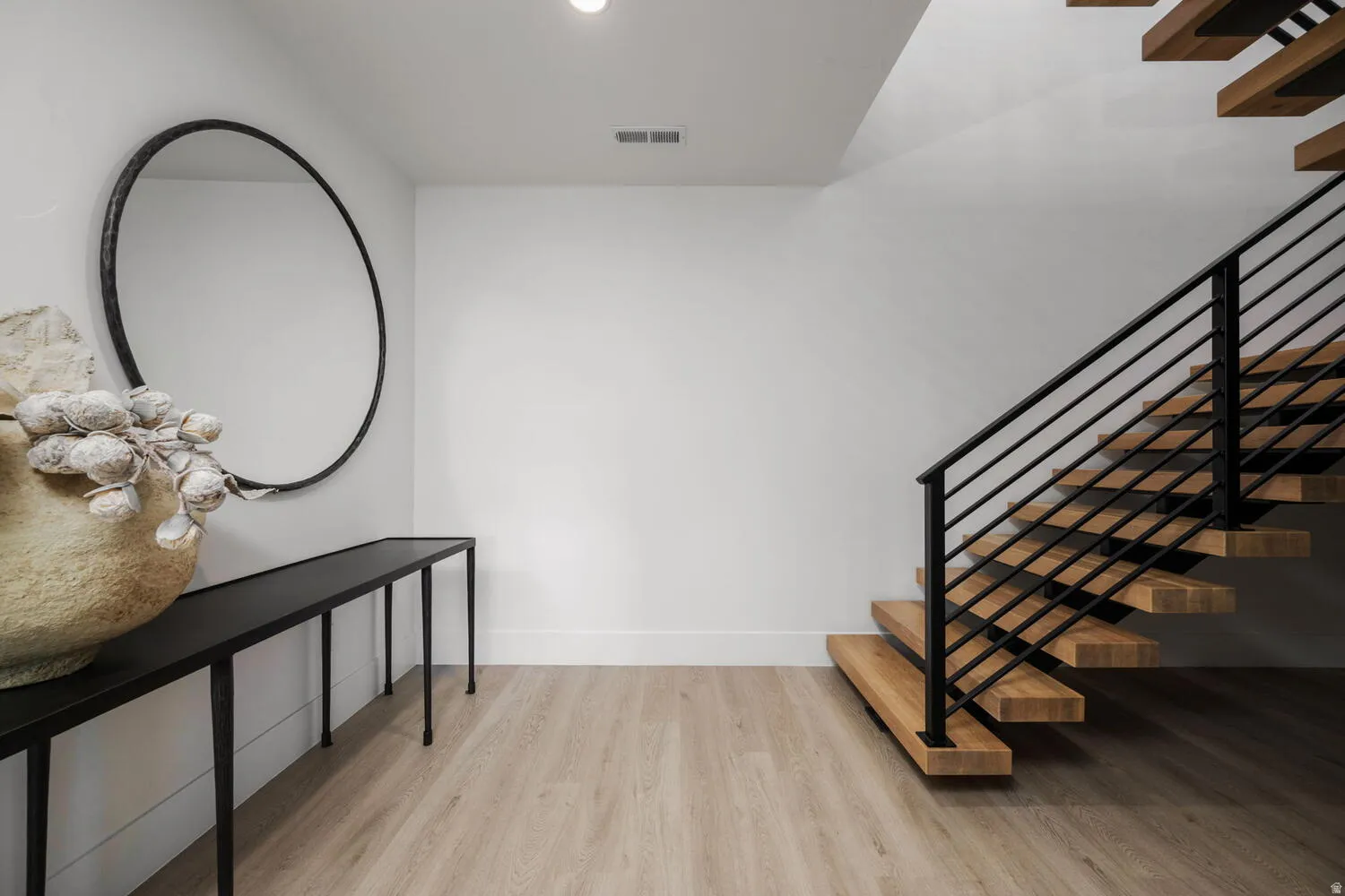 Staircase featuring wood finished floors and baseboards