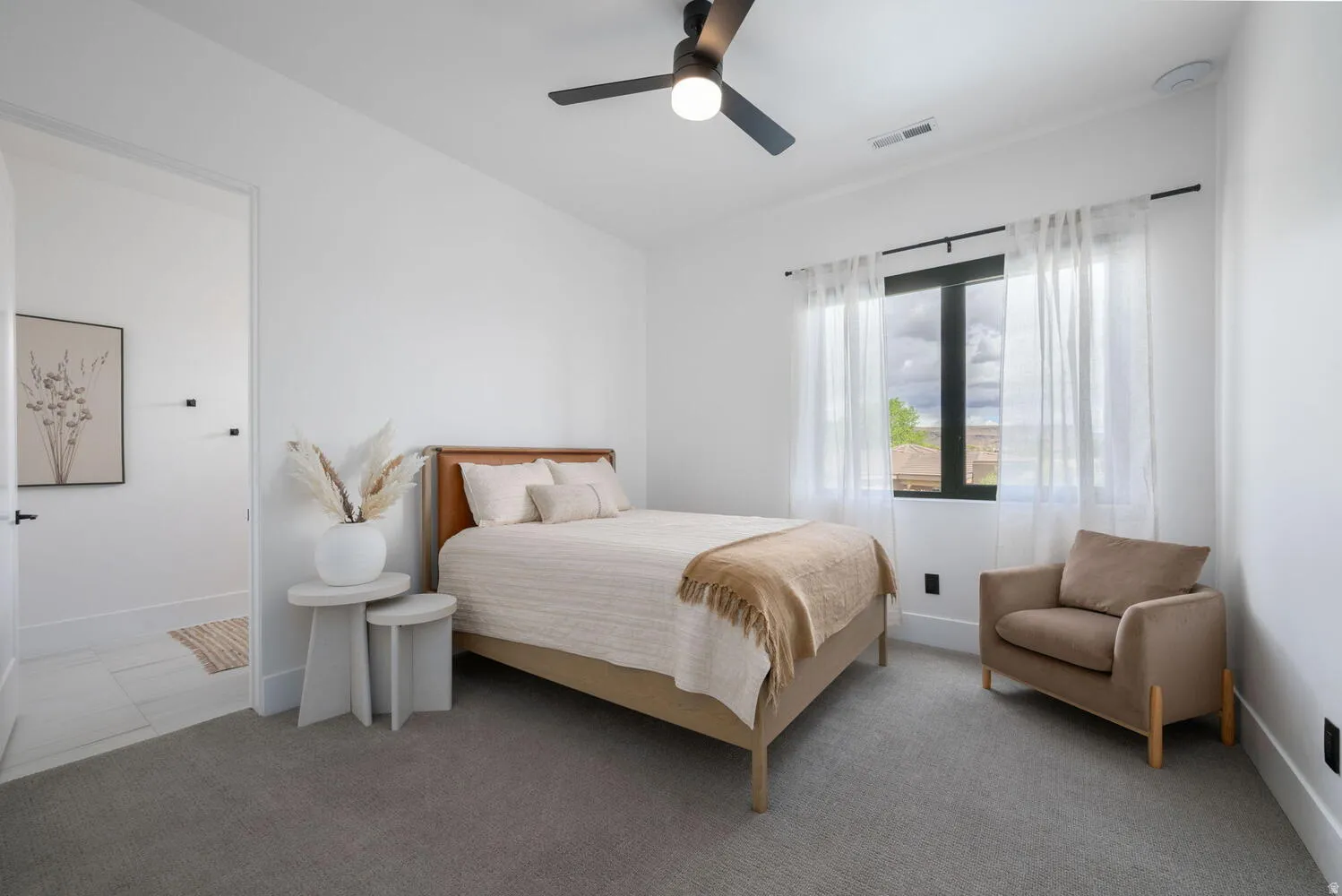Bedroom with light carpet and ceiling fan