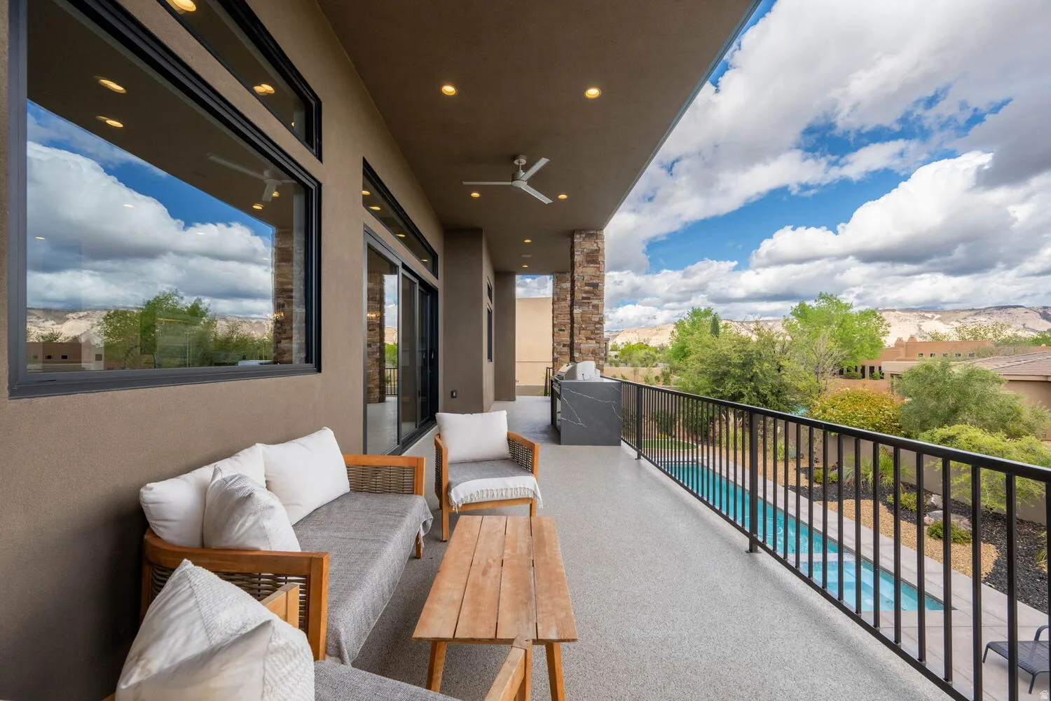 Balcony with view of pool and outdoor lounge area