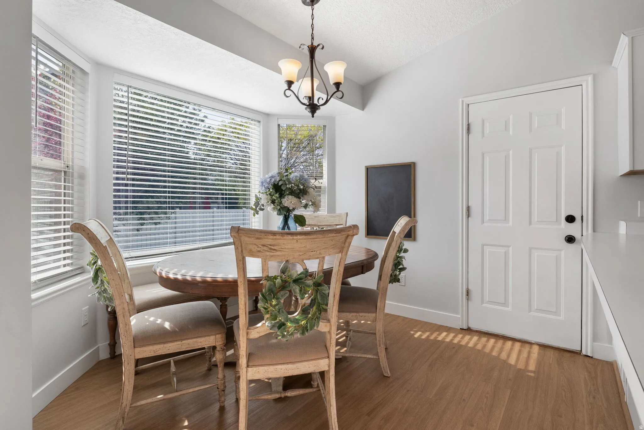 Dining space featuring suspended lighting and wood finished floors