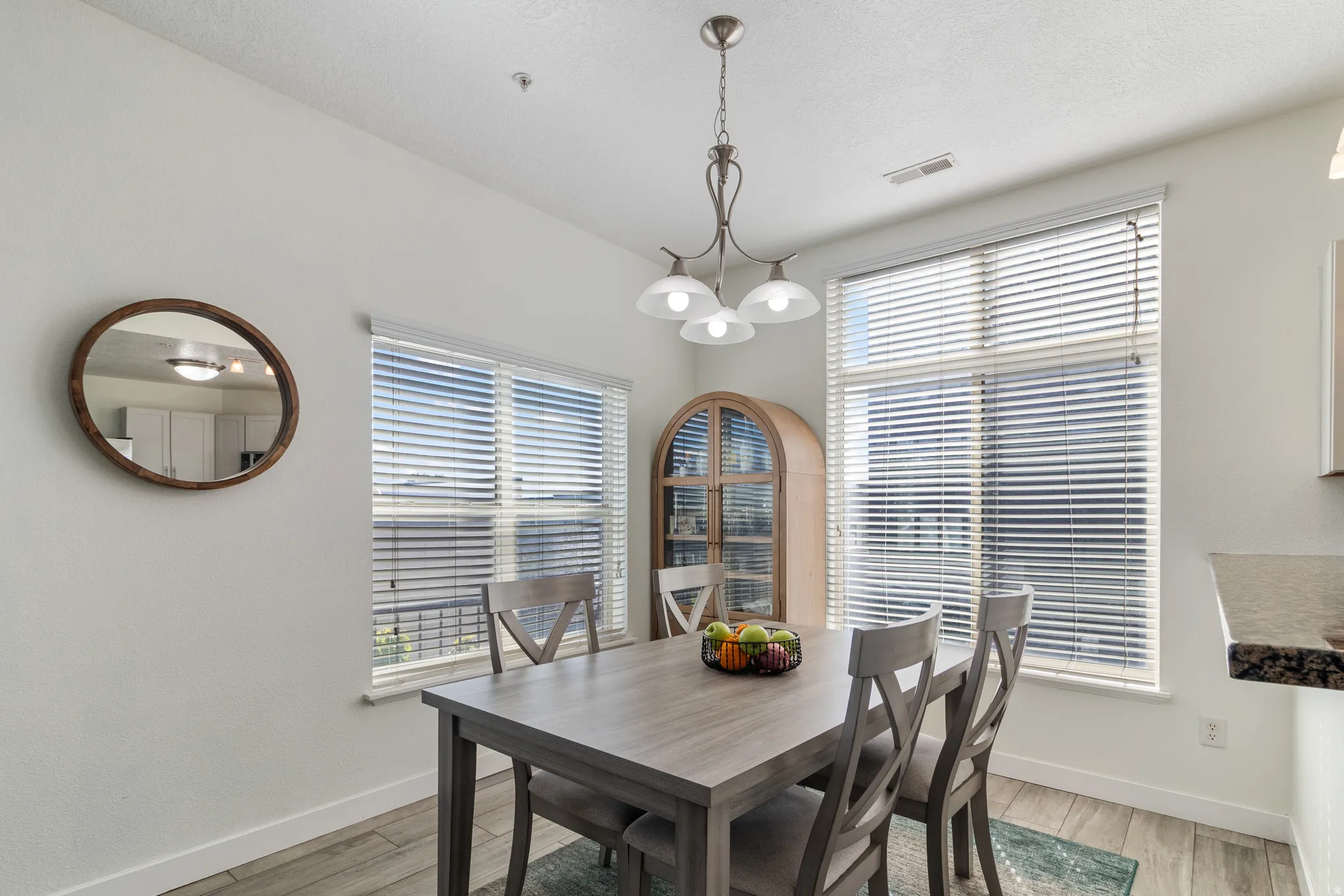 Dining room with suspended lighting.