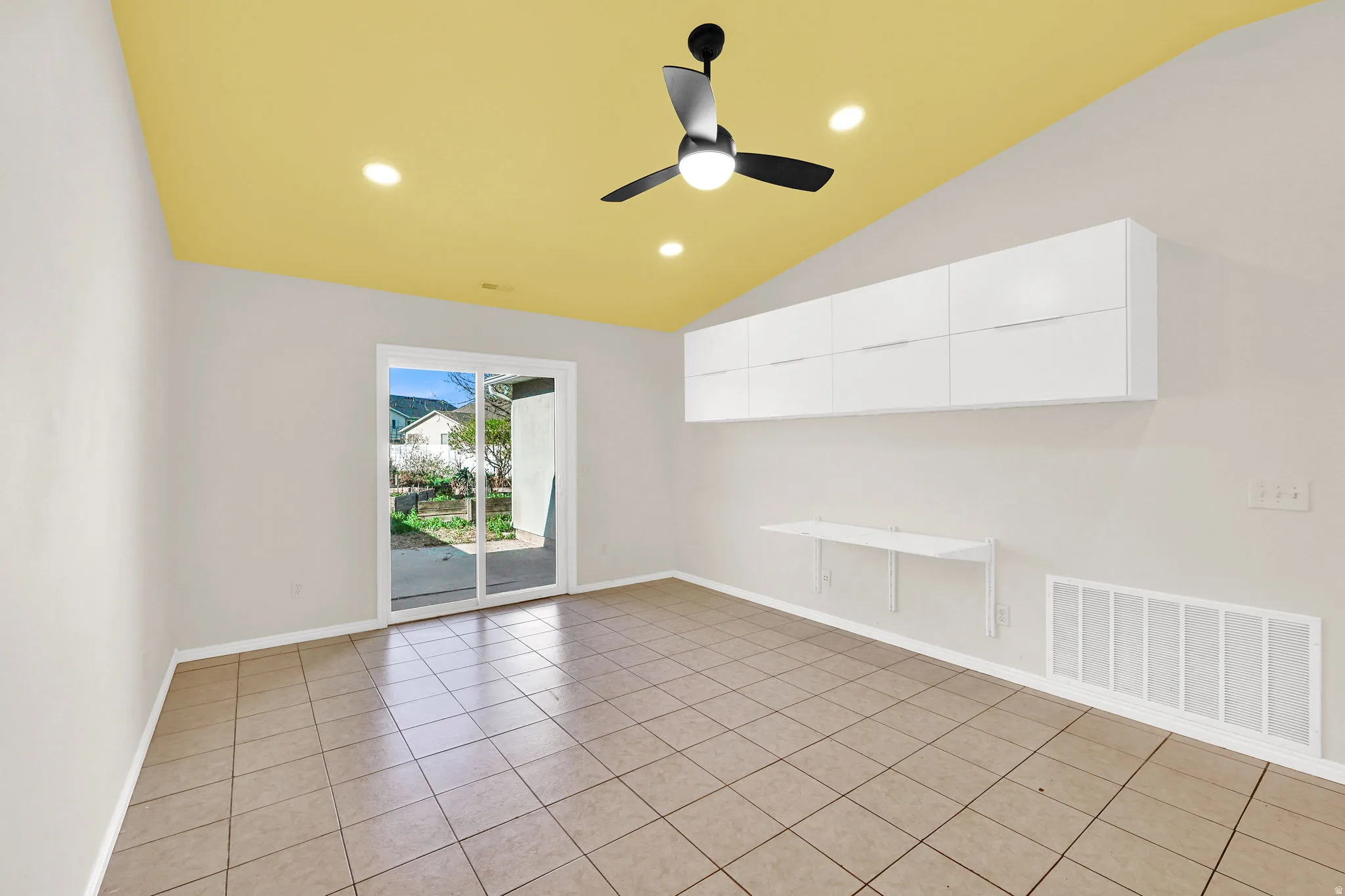 Spare room featuring a ceiling fan, recessed lighting, vaulted ceiling, and light tile patterned floors