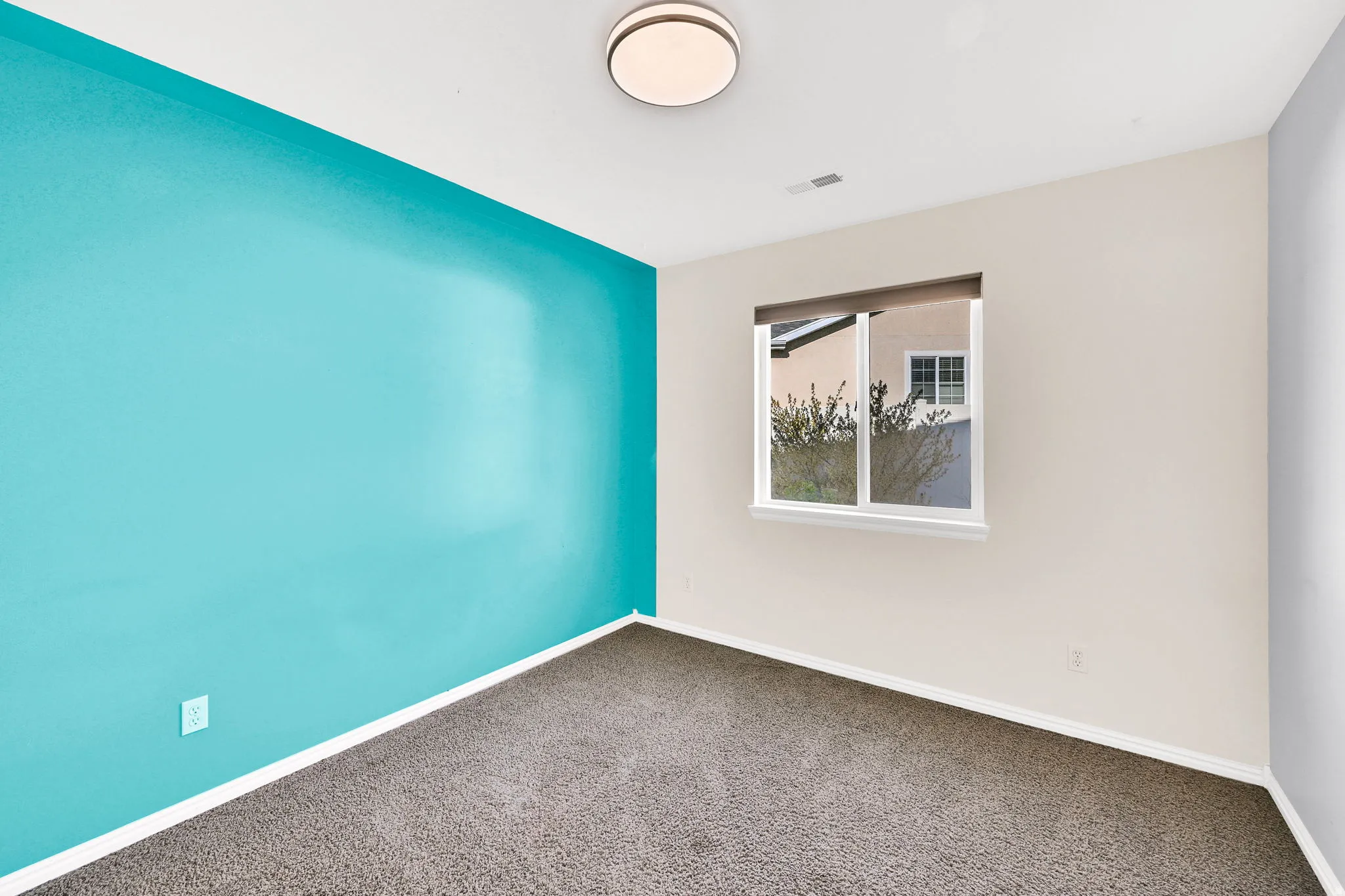 Carpeted empty room featuring baseboards
