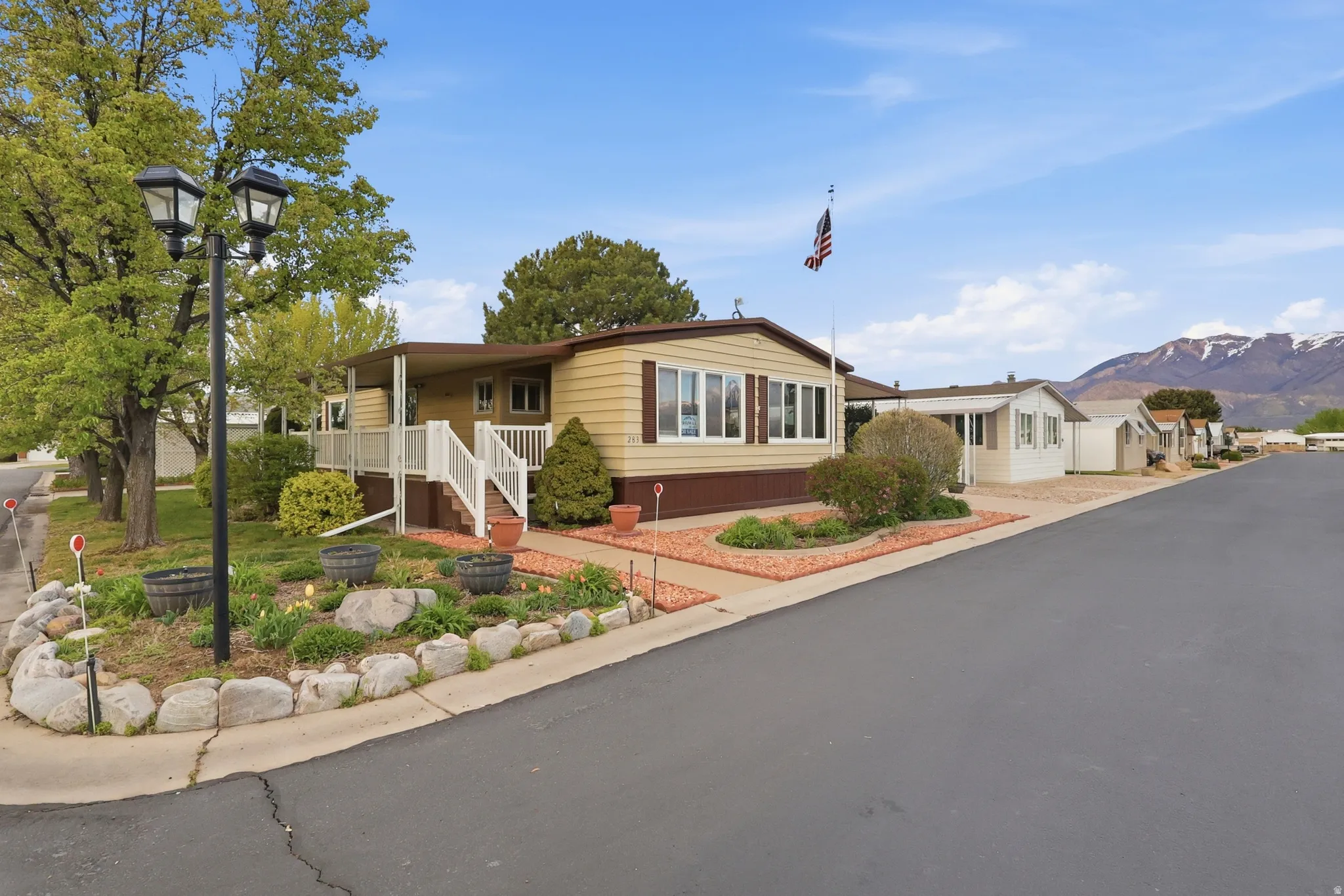 Manufactured / mobile home with a mountain view, covered porch, and a residential view