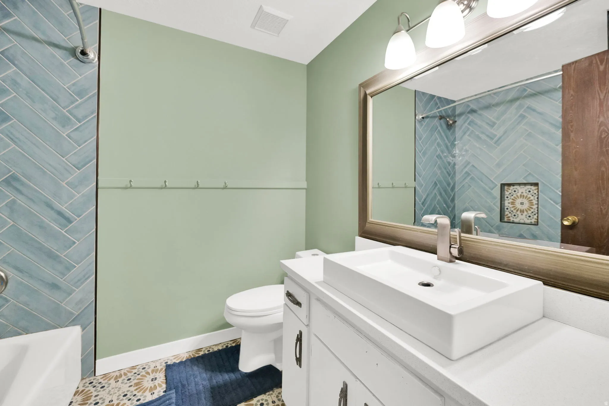 Full bath with vanity, tub / shower combination, and tile patterned floors