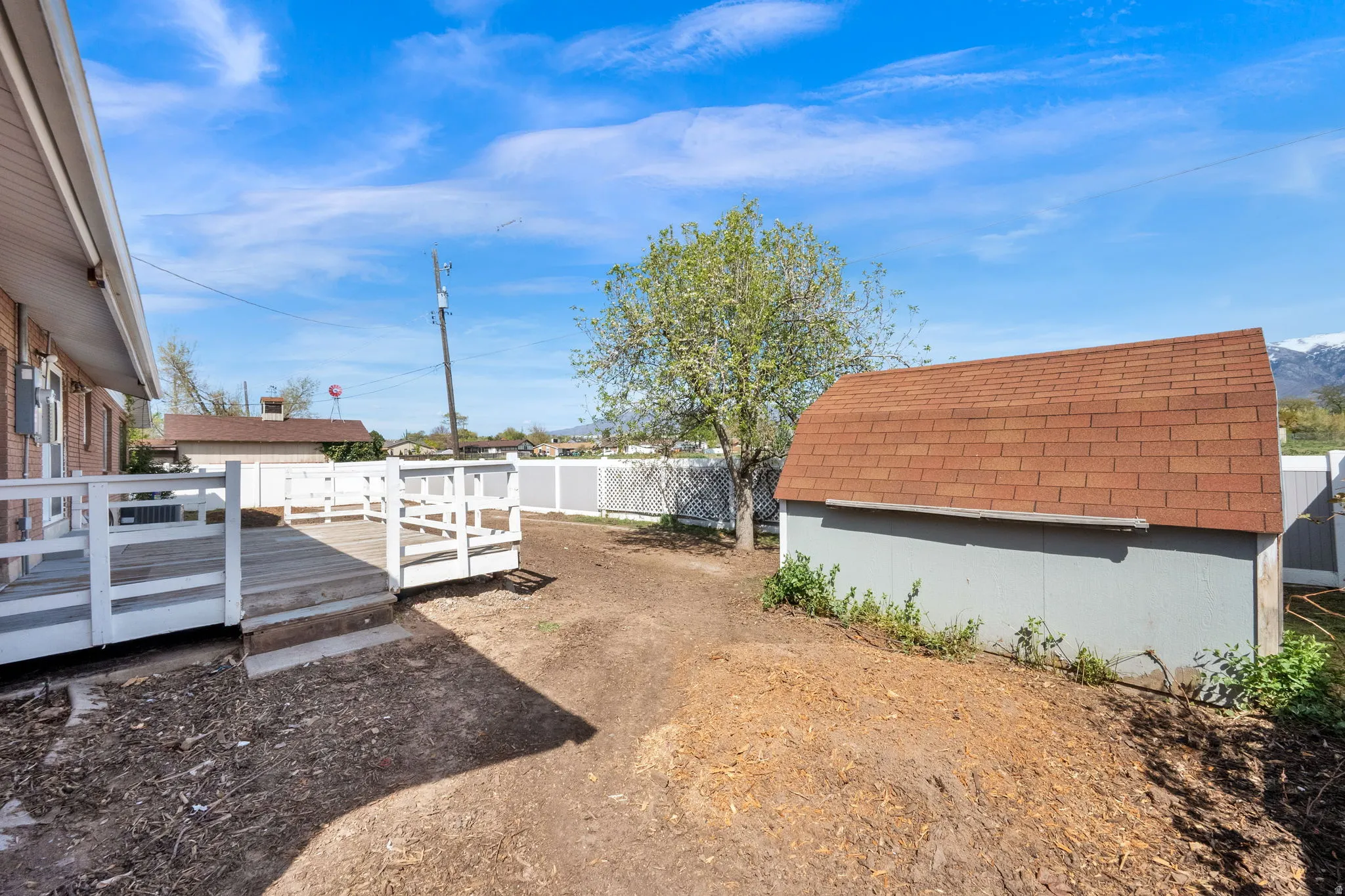 Fenced backyard featuring a deck