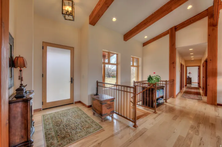 Entrance foyer with vaulted ceiling, light wood finished floors, and recessed lighting
