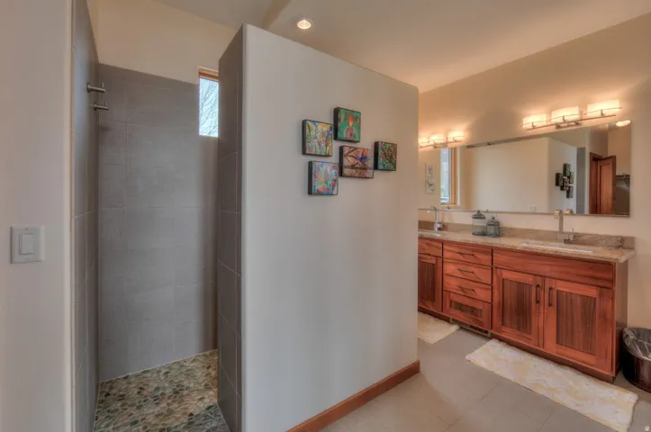 Full bathroom with double vanity and walk in shower