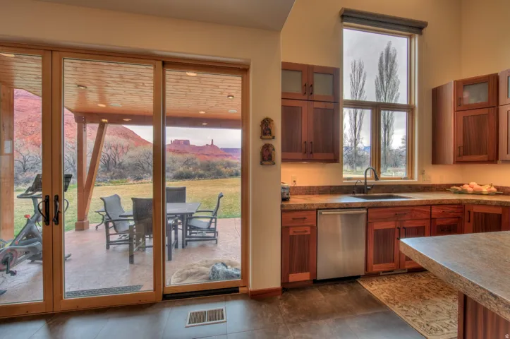 Kitchen with glass fronted cabinets and wood finish cabinetry