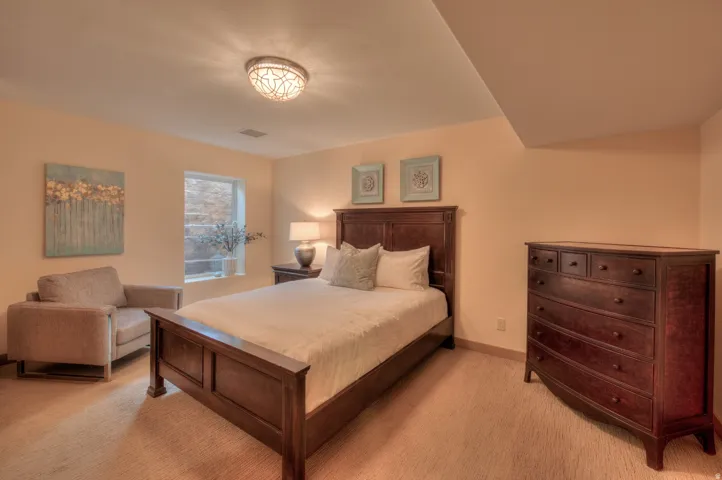 Bedroom with light carpet and baseboards