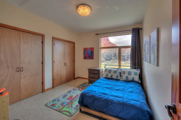 Bedroom with two closets and light carpet