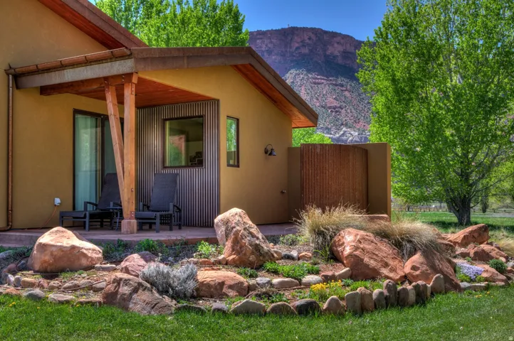 View of side of home featuring a mountain view, a patio, and stucco siding