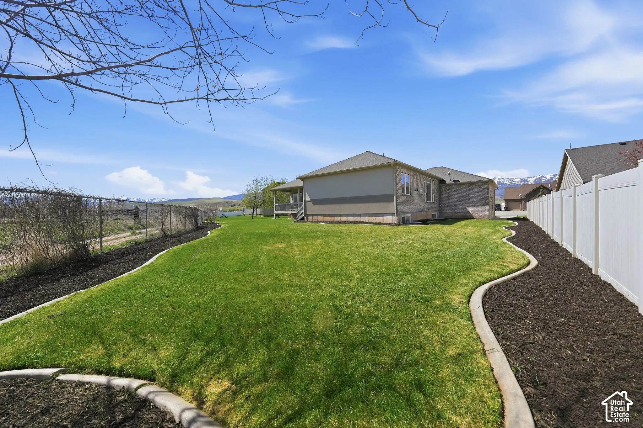 Fenced backyard featuring a mountain view
