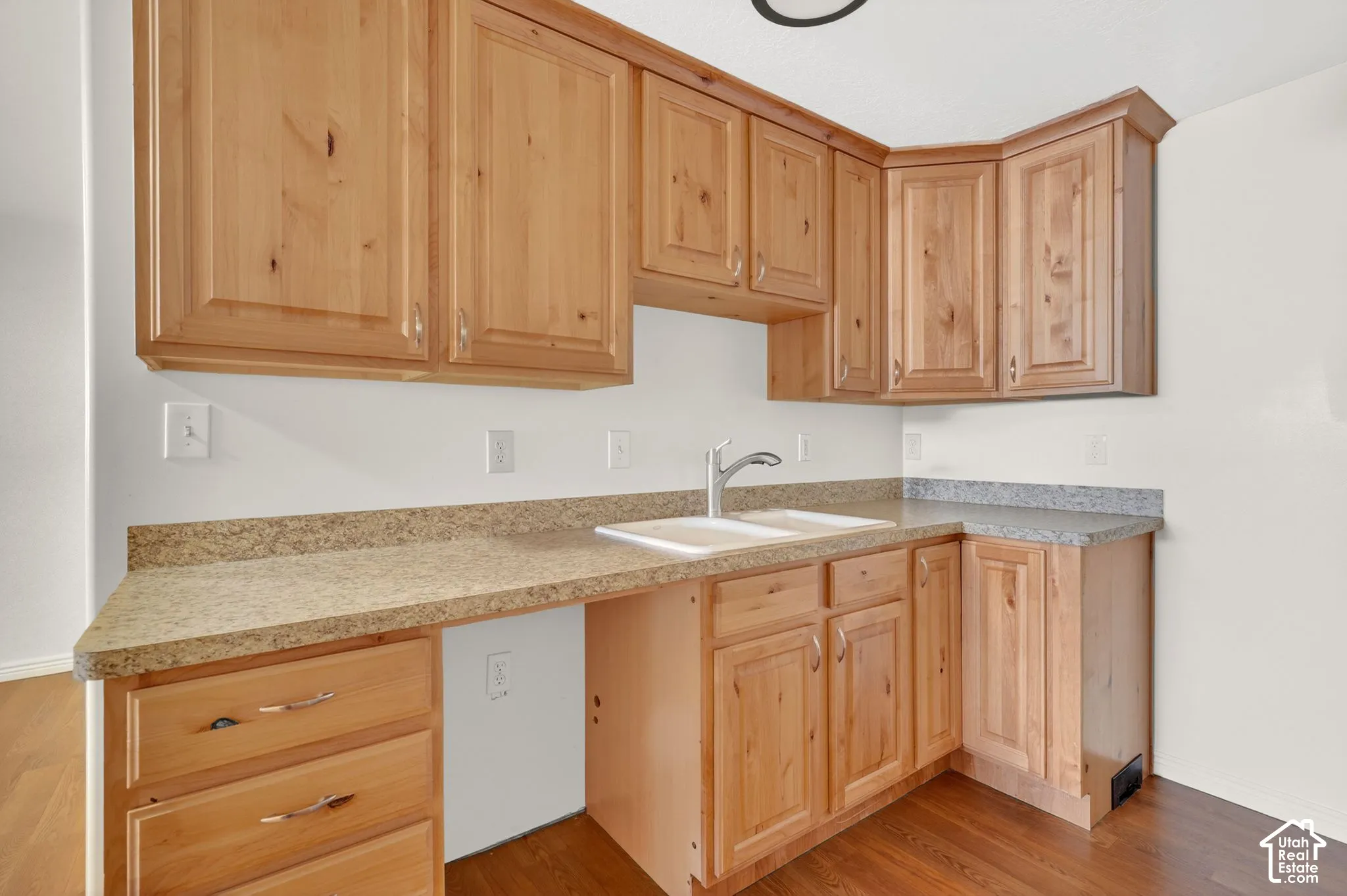 Kitchen with light wood finish cabinets, light countertops, and light wood-type flooring