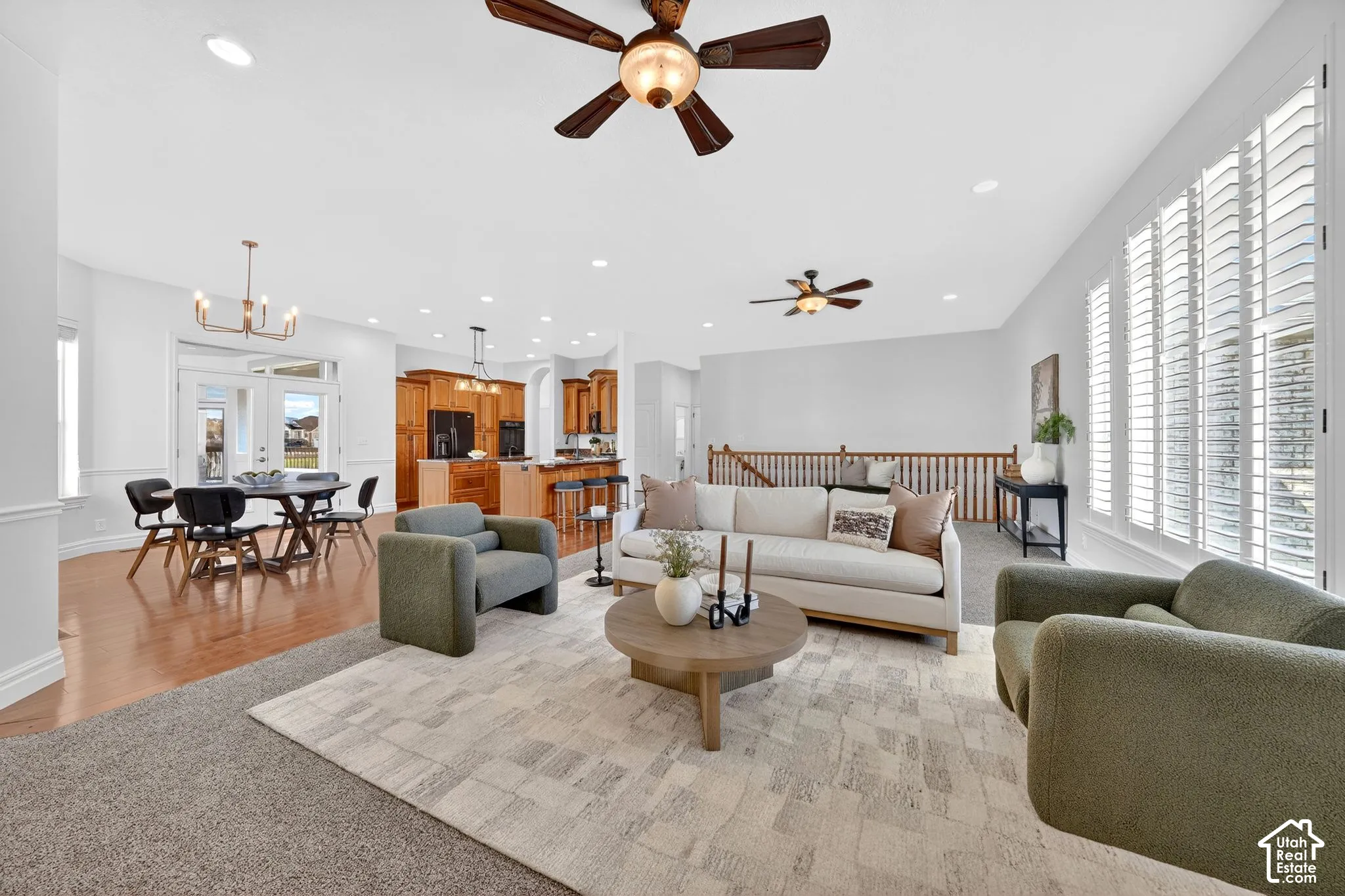 Living area featuring a chandelier and light colored carpet