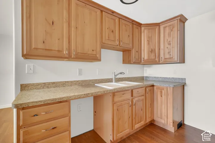 Kitchen with light wood finish cabinets, light countertops, and light wood-type flooring