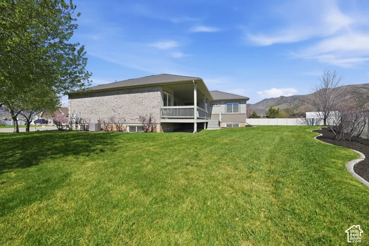 Back of property featuring a mountain view and brick siding