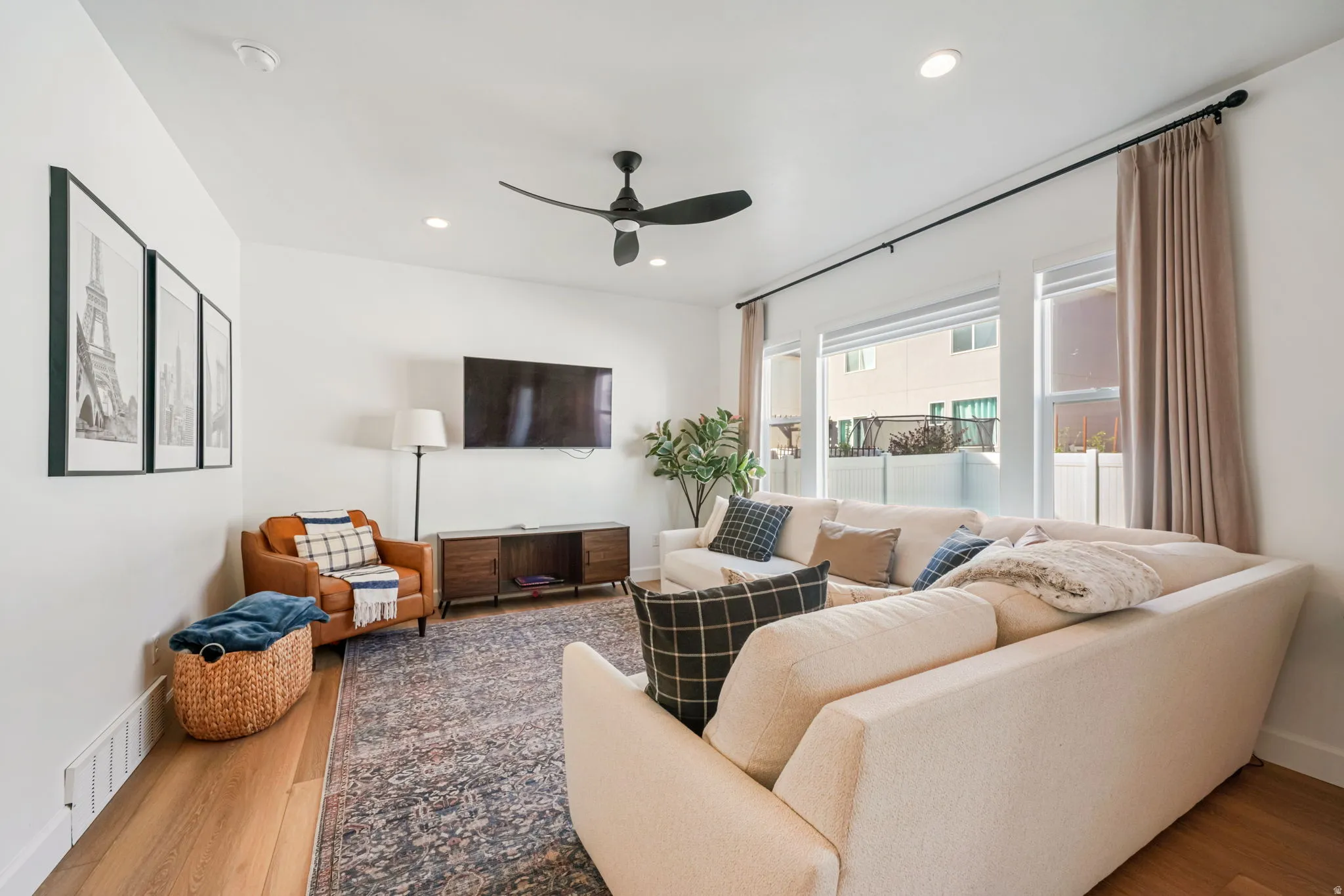 Living room featuring ceiling fan, light wood-style flooring, and recessed lighting