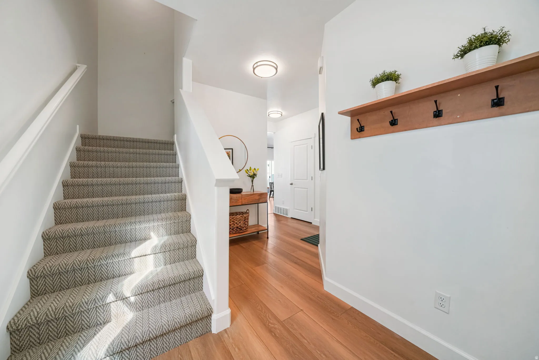 Stairs with baseboards and wood finished floors