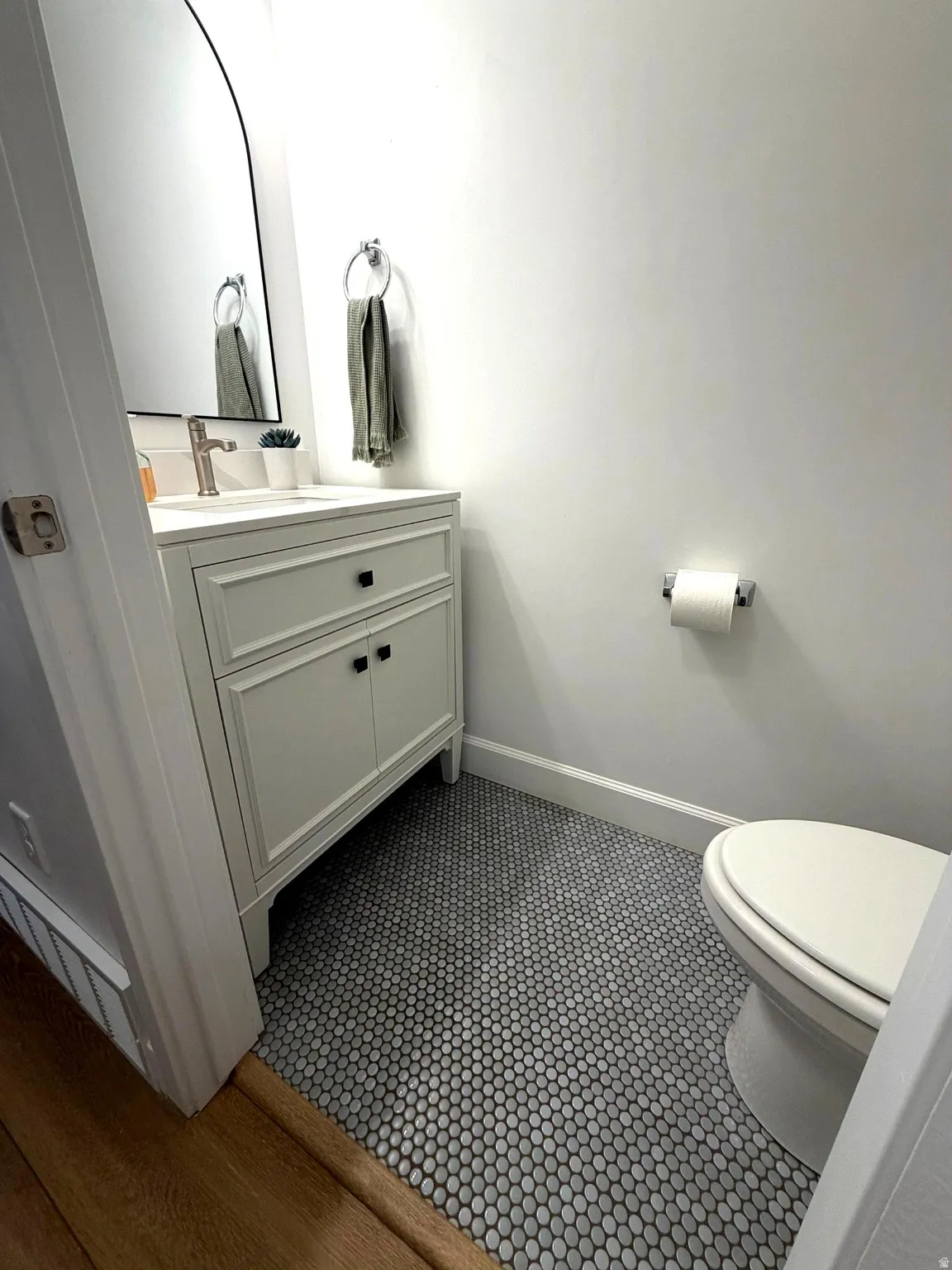 Half bath with vanity and toilet