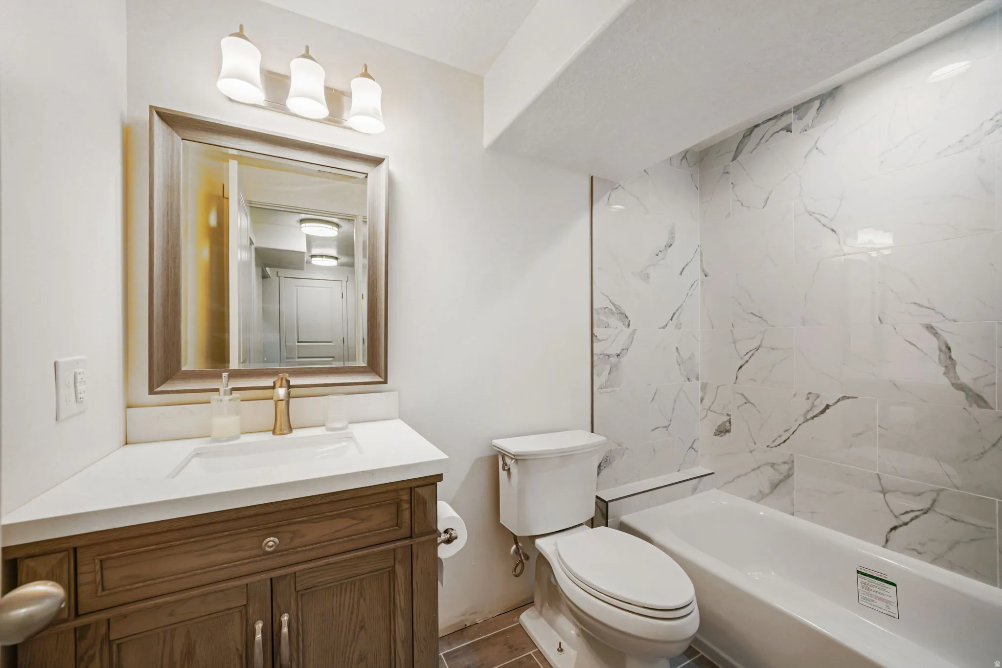 Full bath with vanity and shower / tub combination